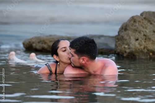 couple kissing in sea