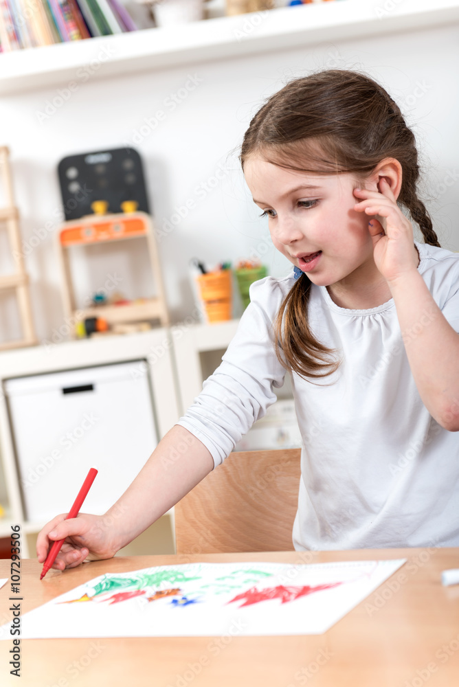 cute happy little girl enjoys creative drawing at preschool cute happy little girl enjoys creative drawing at preschool