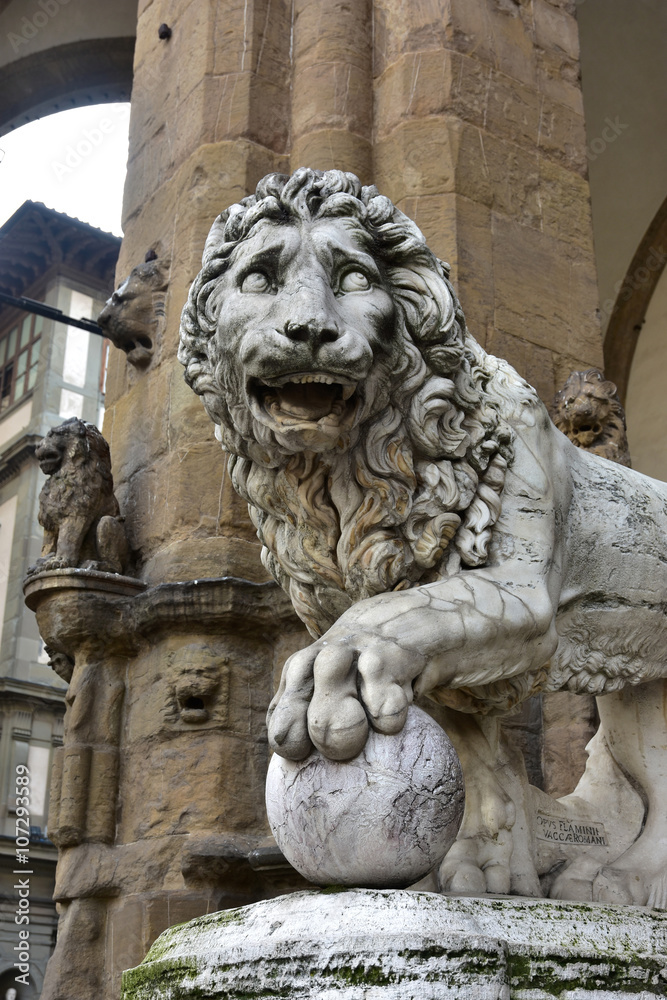 Medici Lion holds the globe in Piazza della Signoria. Marble lion statue at the entrance (left side) of Loggia dei Lanzi in Florence, made by artist Flaminio Vacca in 1598