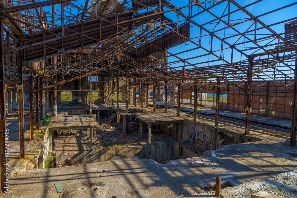 Ruins of an abandoned old factory. The remains of the steel stru