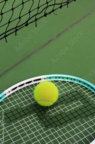 Tennis ball and racket on tennis court © phaitoon