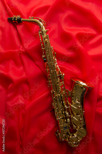 beautiful golden saxophone on a red background