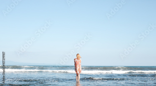 Portrait of young woman looking at the ocean
