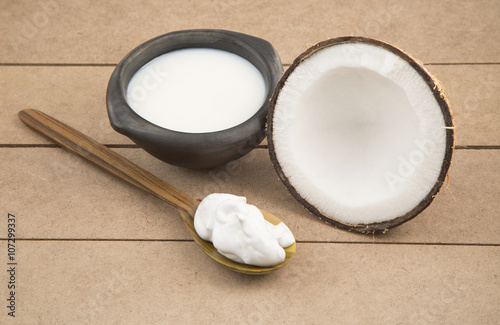 Oil and coconut cream on wooden background