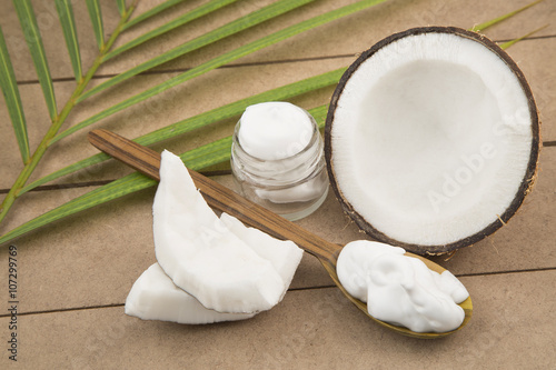 Oil and coconut cream on wooden background