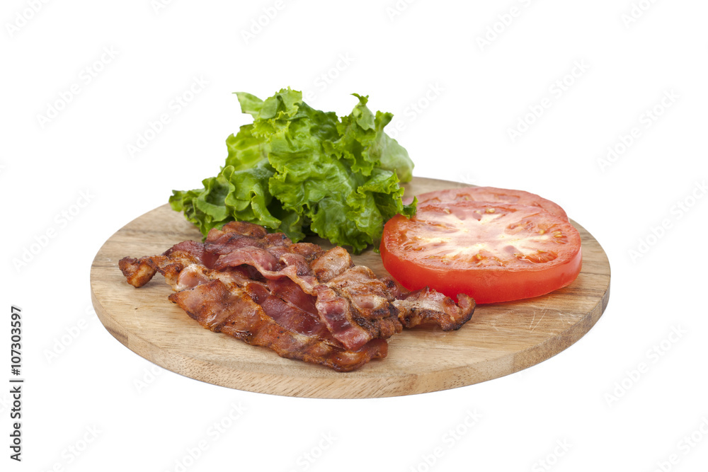 a wooden plate with bacon, lettuce and tomato