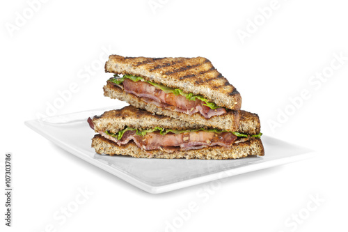 a plate with two bacon sandwich