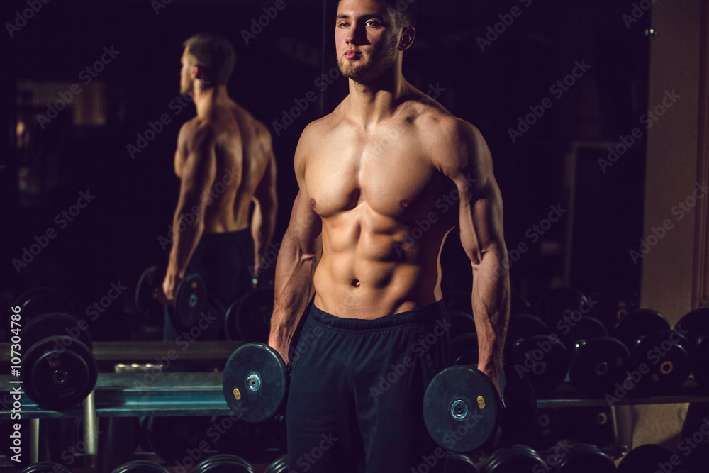 Very power athletic guy bodybuilder , execute exercise with dumbbells Very power athletic guy bodybuilder , execute exercise with dumbbells