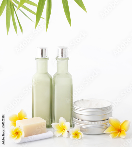 Cosmetic products on the white background with bamboo leaves