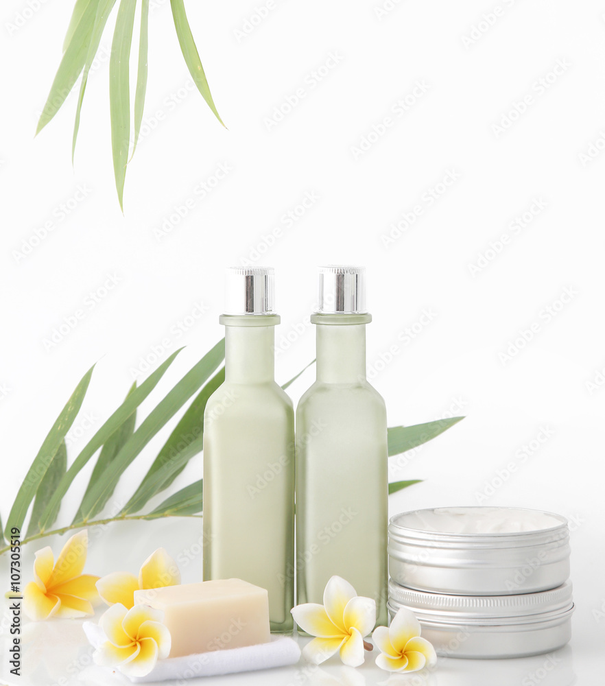 Spa concept - natural cosmetic products with bamboo and frangipani flower on white