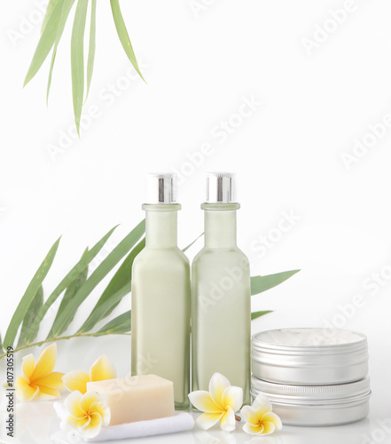 Spa concept - natural cosmetic products with bamboo and frangipani flower on white