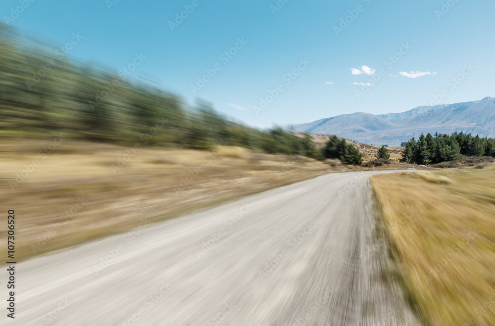 empty rural road through pasture in fine day in new zealand empty rural road through pasture in fine day in new zealand