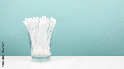The group of purified white cotton buds in shot glass.