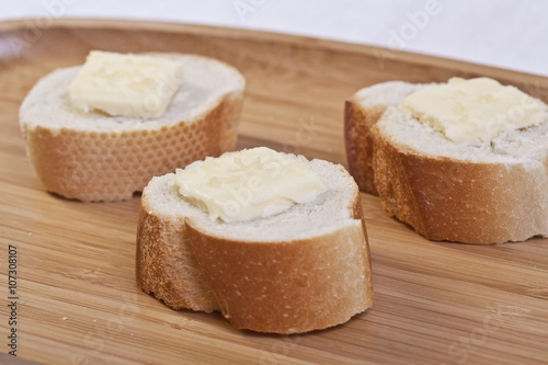 three slices of baguette bread with butter