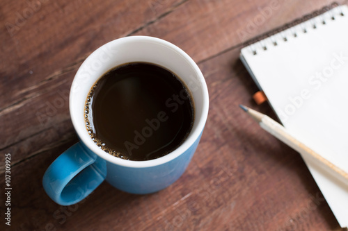 cup of coffee on wooden table closeup
