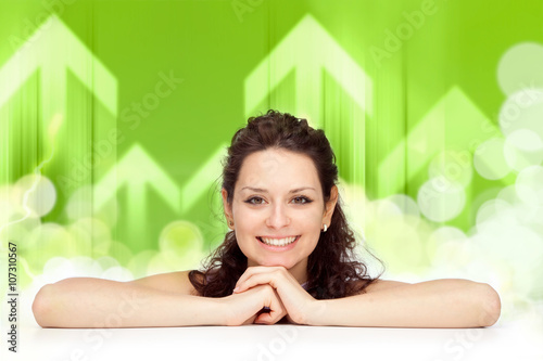 beautiful young brunette girl smile lean on white table arrow background