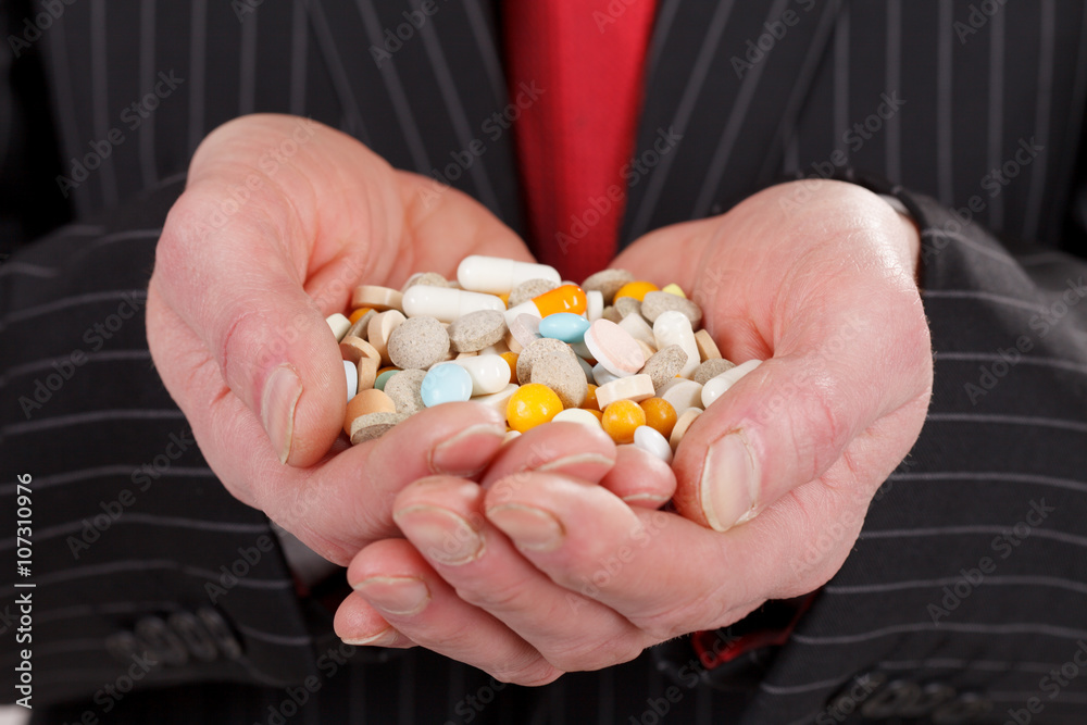 man holding pills man holding pills