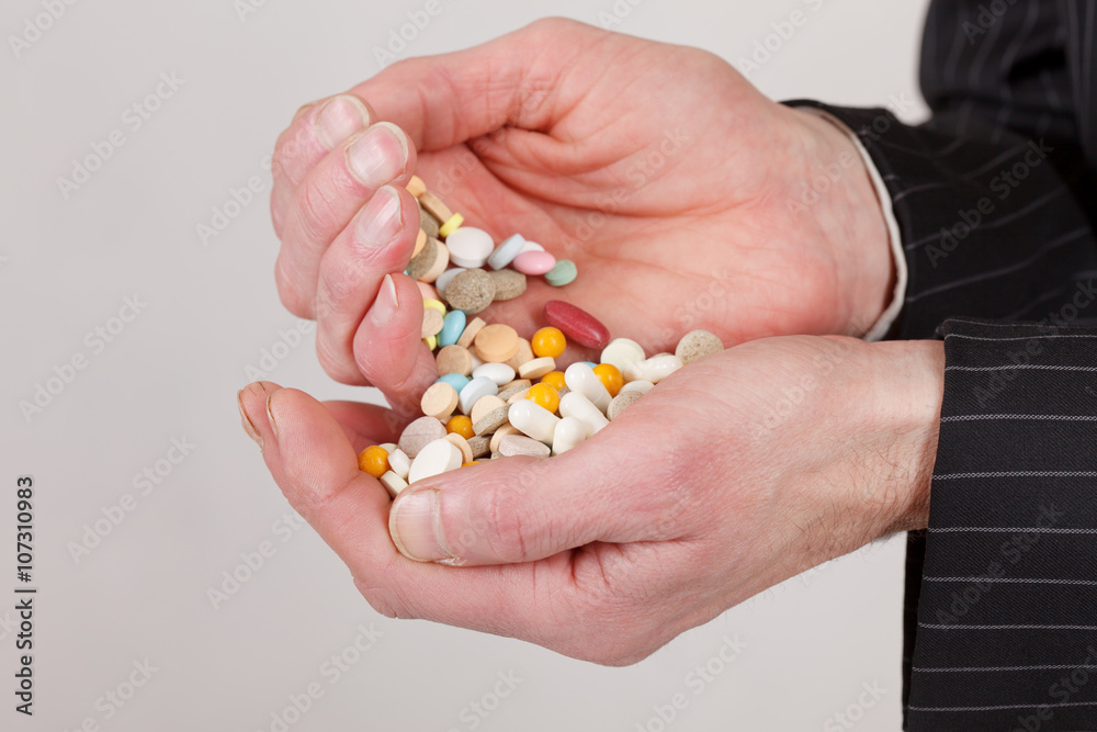 man holding pills man holding pills