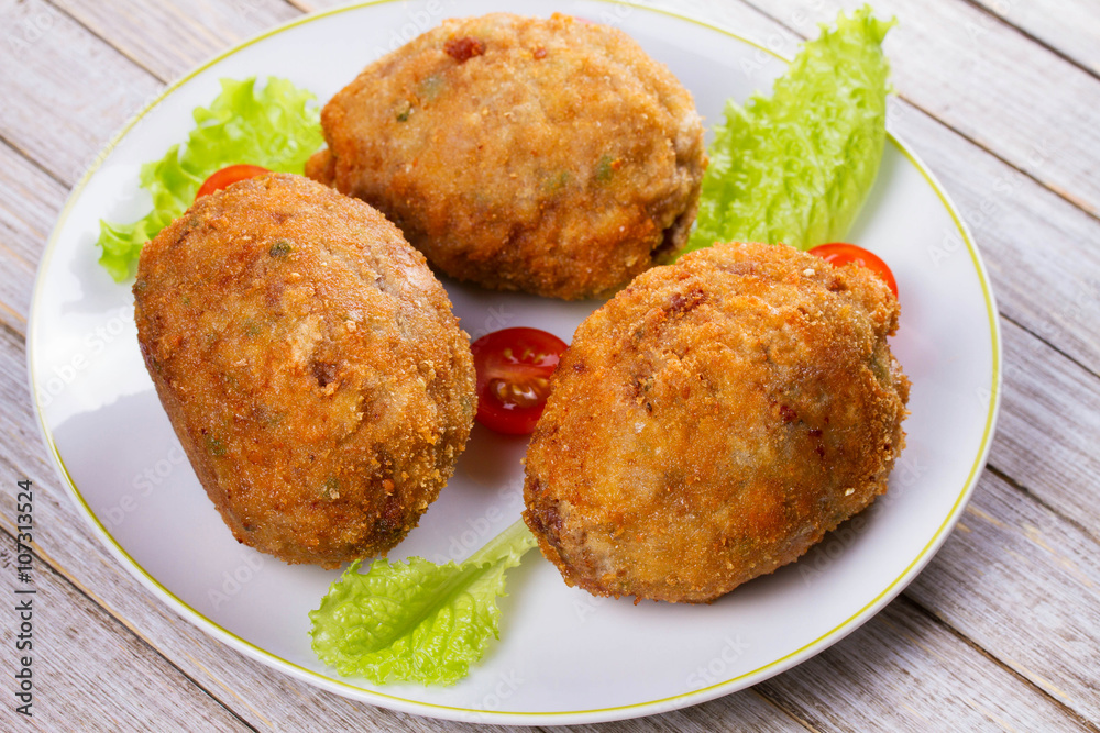 Scotch Eggs Served with Tomato Cherry and Salad on White Plate Scotch Eggs Served with Tomato Cherry and Salad on White Plate