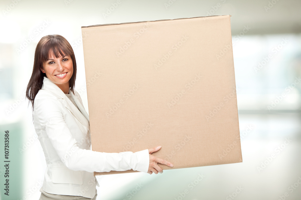 beautiful young girl hold a box in a interior background beautiful young girl hold a box in a interior background