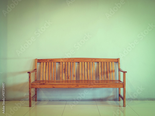 wooden bench against the concrete wall