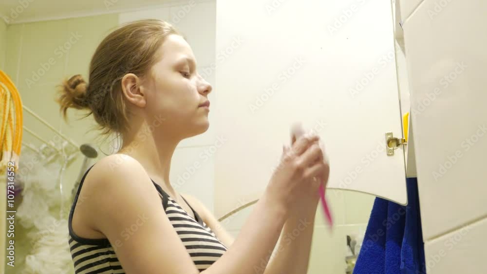 Teen girl brushes her teeth, 4K Teen girl brushes her teeth, 4K