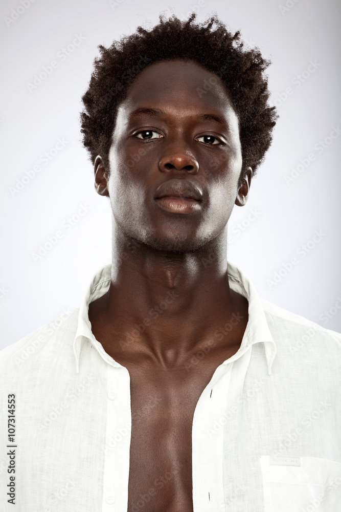 handsome young black man with white shirt isolated on grey handsome young black man with white shirt isolated on grey