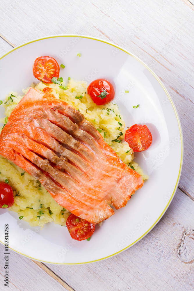 Salmon, Tomato and Smashed Potato with Spring Onion and Coriander. View From Above, Top Studio Shot Salmon, Tomato and Smashed Potato with Spring Onion and Coriander. View From Above, Top Studio Shot