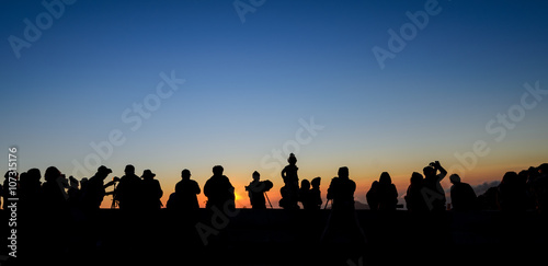 Silhouette tourists and photographers with beautiful sunrise