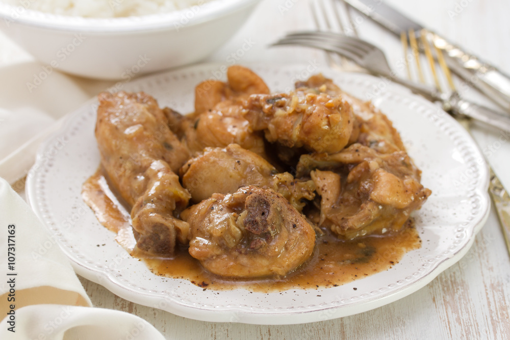 boiled chicken with beer sauce in white plate and rice in bowl on white background boiled chicken with beer sauce in white plate and rice in bowl on white background