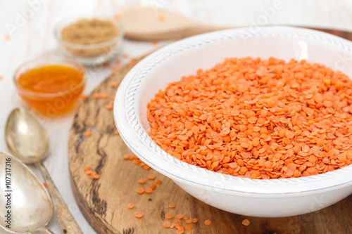 red lentils in white bowl with jam and brown sugar