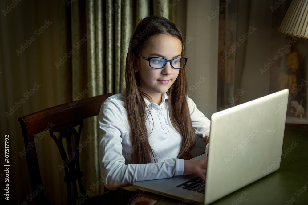 Portrait of beautiful girl using laptop at late evening Portrait of beautiful girl using laptop at late evening