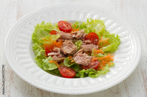 tuna salad on white plate on white wooden background