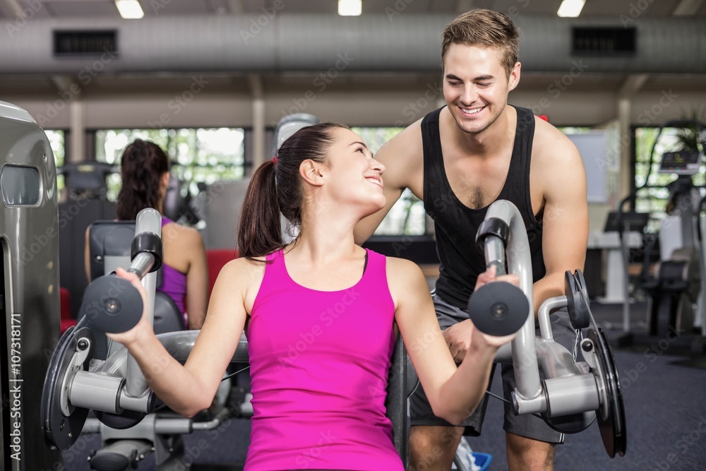 Trainer man helping athletic woman Trainer man helping athletic woman