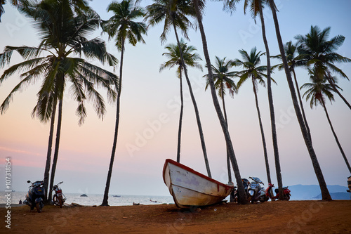 Sunset on a tropical beach with a boat