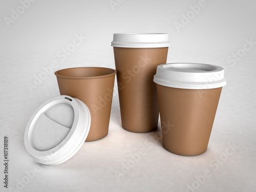 Three different size paper cups for coffee with plastic caps on
