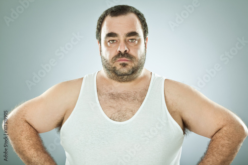 funny fat macho man isolated on grey