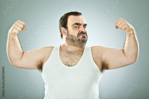 funny fat macho man isolated on grey