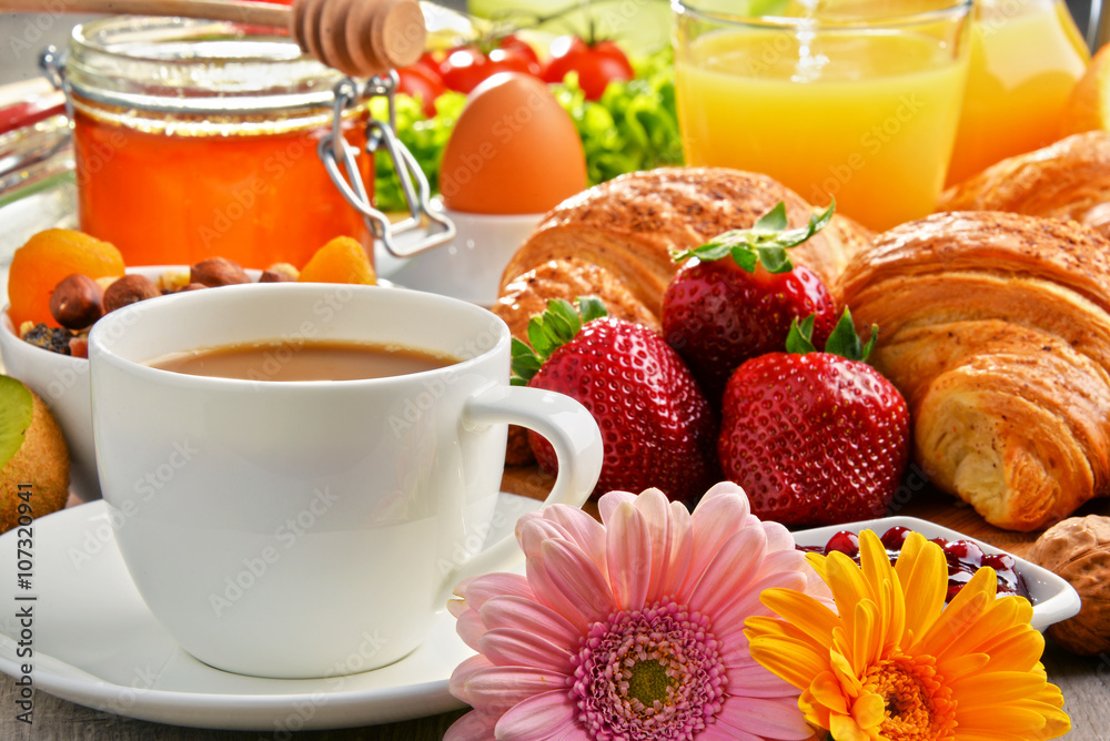 Breakfast consisting of croissants, coffee, fruits, orange juice Breakfast consisting of croissants, coffee, fruits, orange juice