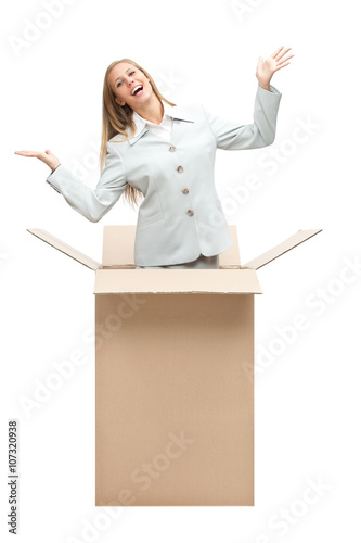 beautiful happy businesswoman come out to of the box isolated on white