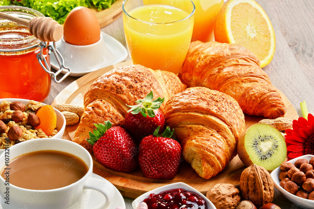 Breakfast consisting of croissants, coffee, fruits, orange juice Breakfast consisting of croissants, coffee, fruits, orange juice