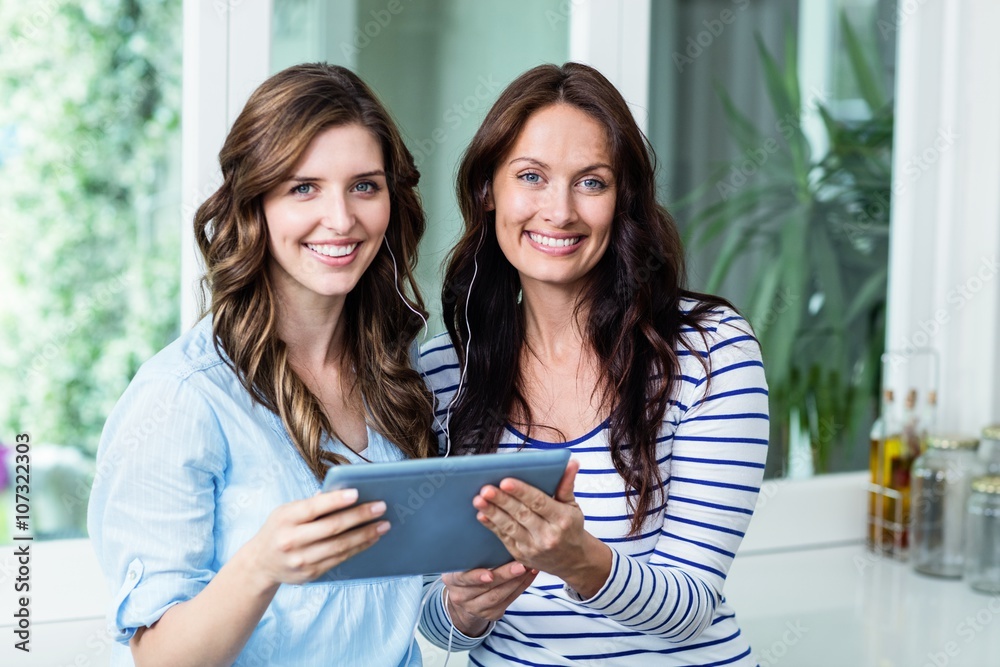 Portrait of happy friends watching video on digital tablet Portrait of happy friends watching video on digital tablet