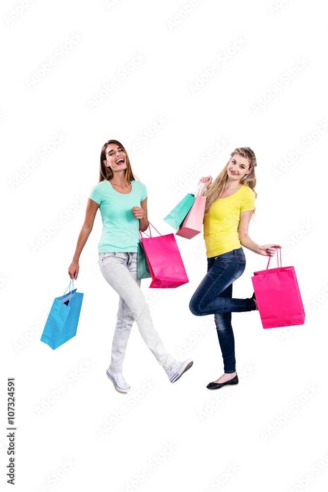 Portrait of smiling female friends holding shopping bags