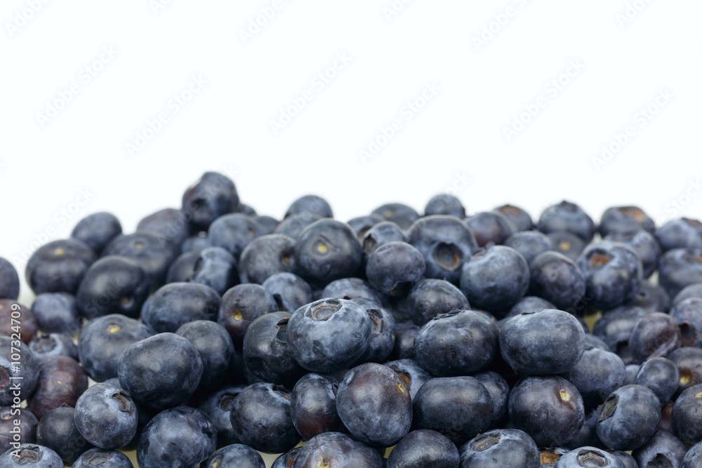 Stack of fresh blueberries, on white background with copy-space Stack of fresh blueberries, on white background with copy-space