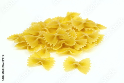 Heap of farfalle pasta, on white background.
