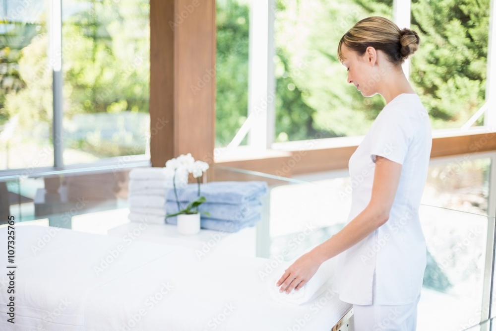 Female masseur rolling towel Female masseur rolling towel