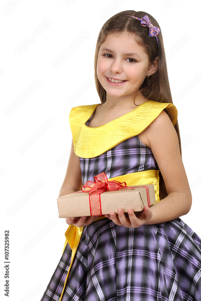 cheerful little girl in a beautiful dress holding a gift with a red ribbon on a white isolated background cheerful little girl in a beautiful dress holding a gift with a red ribbon on a white isolated background