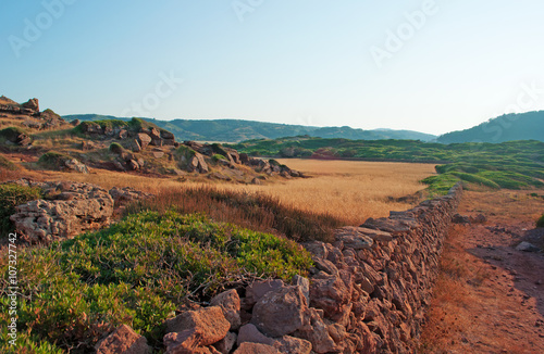 Minorca, isole Baleari: sabbia rossa e campi di grano sul sentiero per Cala Pregonda, la baia simile al pianeta Marte, il 15 luglio 2013