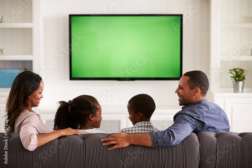 Parents and children watching TV, looking at each other