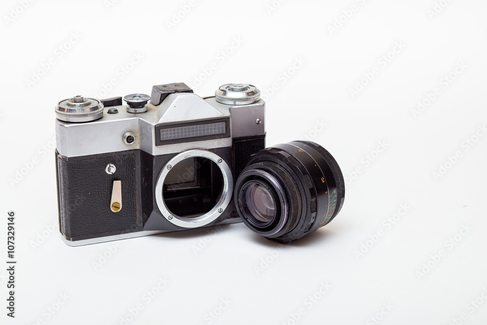 vintage film camera with lens detached and body